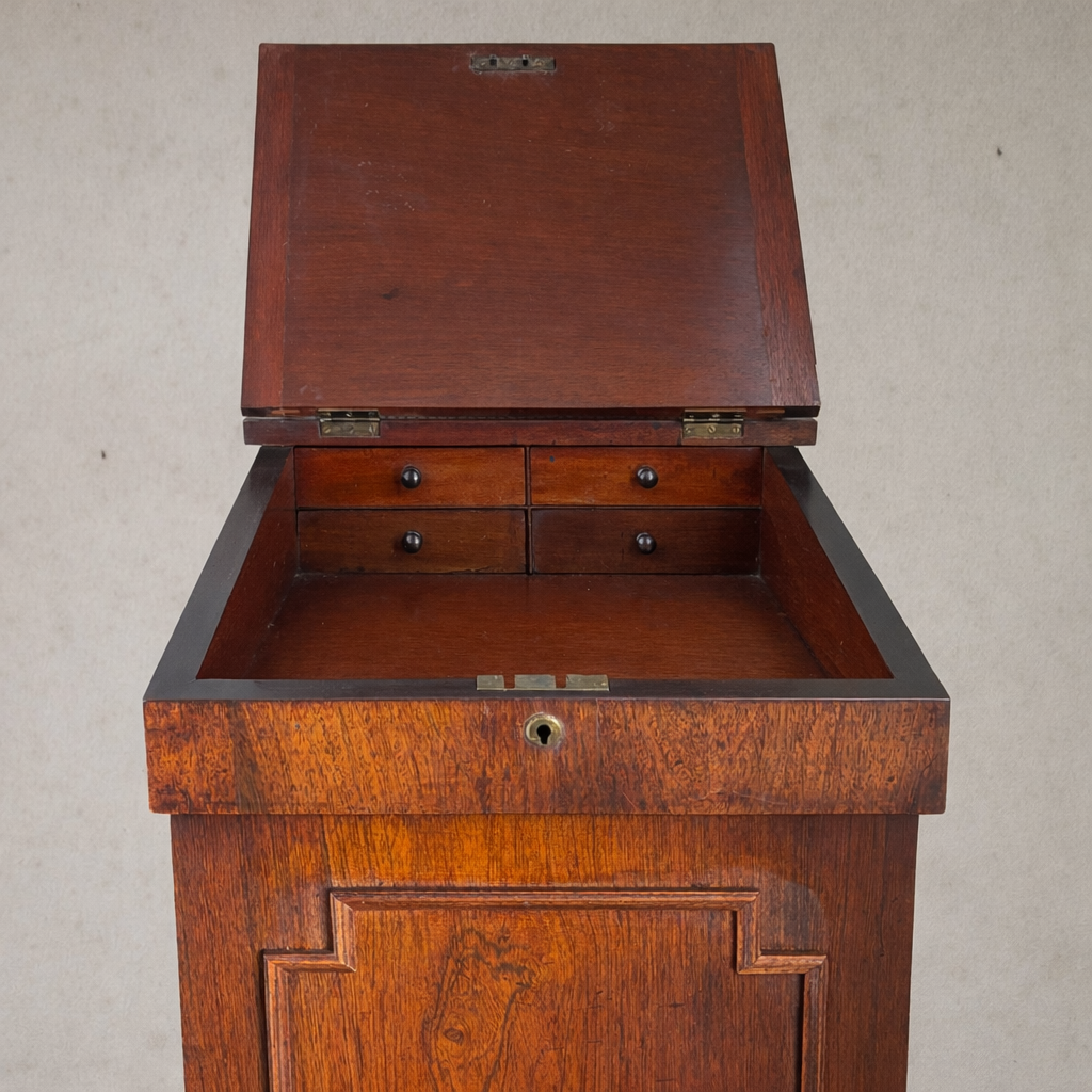 Interior view of antique writing desk showing storage drawers and hand-finished wood interior