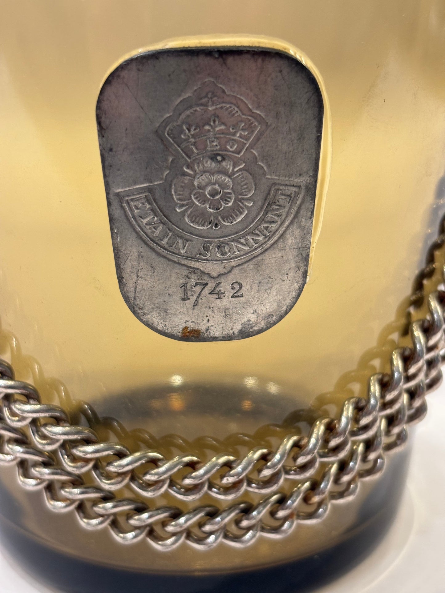 Amber glass ice bucket with pewter medallion and chain, England, 1950s
