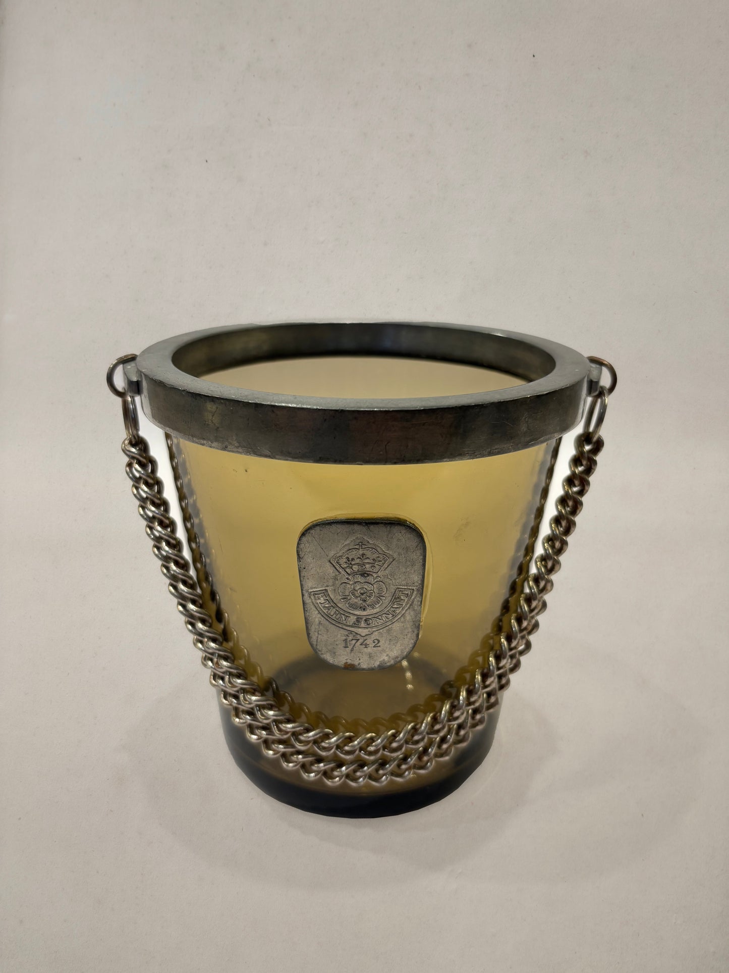 Amber glass ice bucket with pewter medallion and chain, England, 1950s