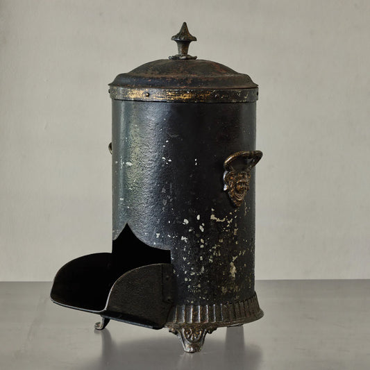 Antique English coal scuttle in black painted tin with finial lid and claw feet, circa 1860