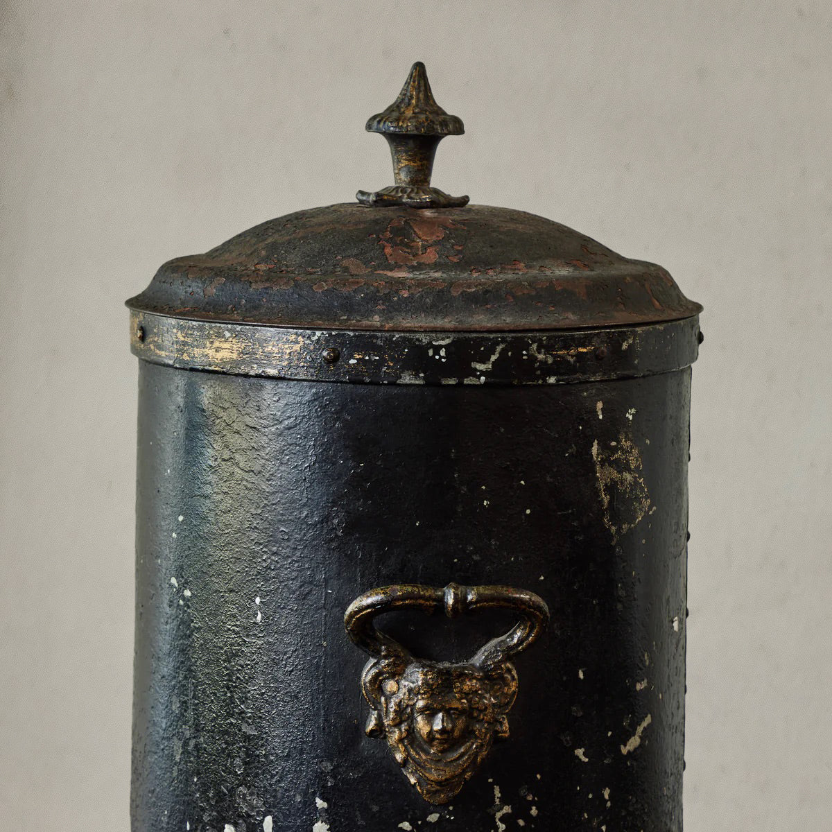 Antique English coal scuttle in black painted tin with finial lid and claw feet, circa 1860
