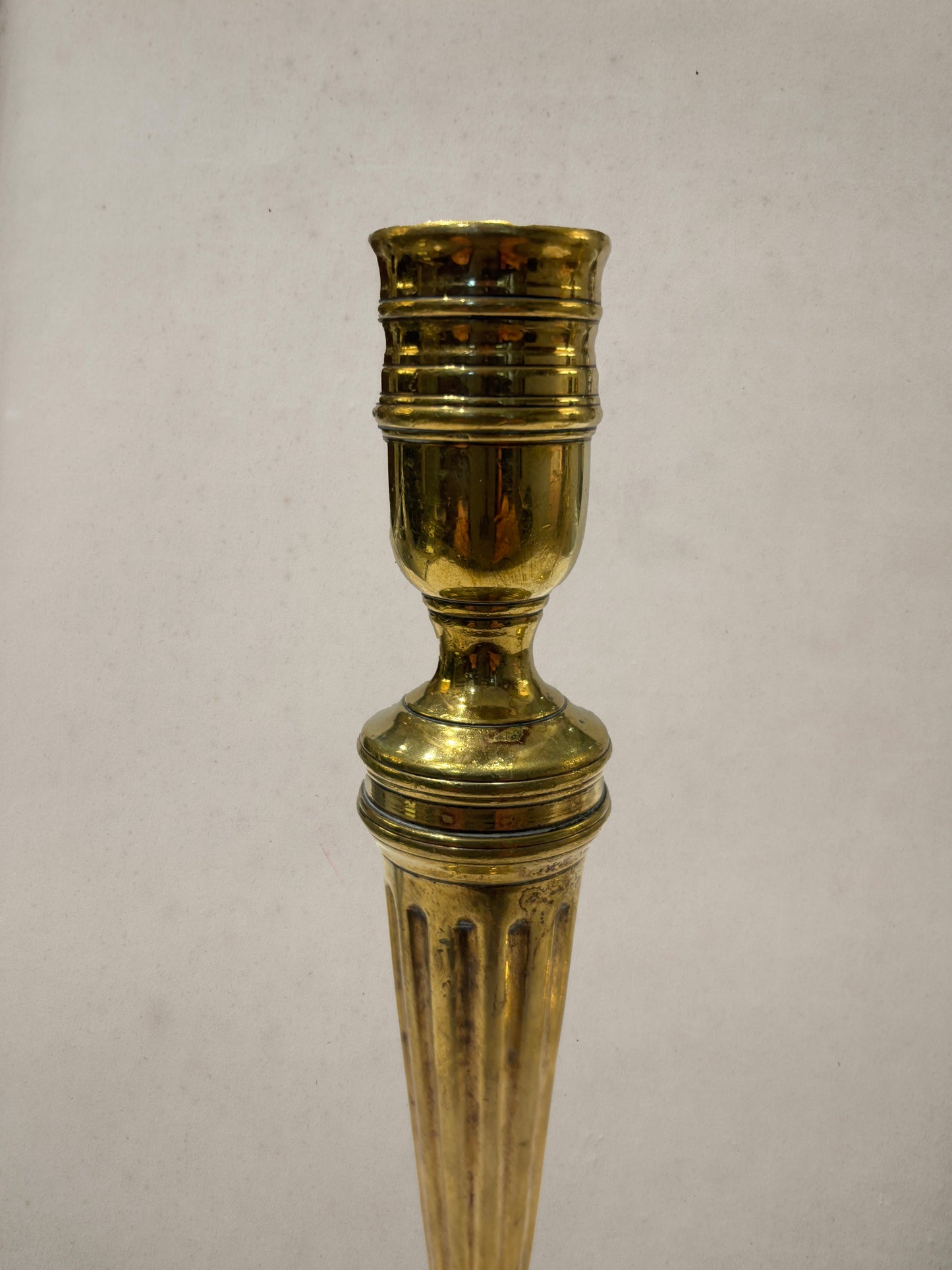 Pair of Georgian brass candlesticks with fluted columns and beaded square bases
