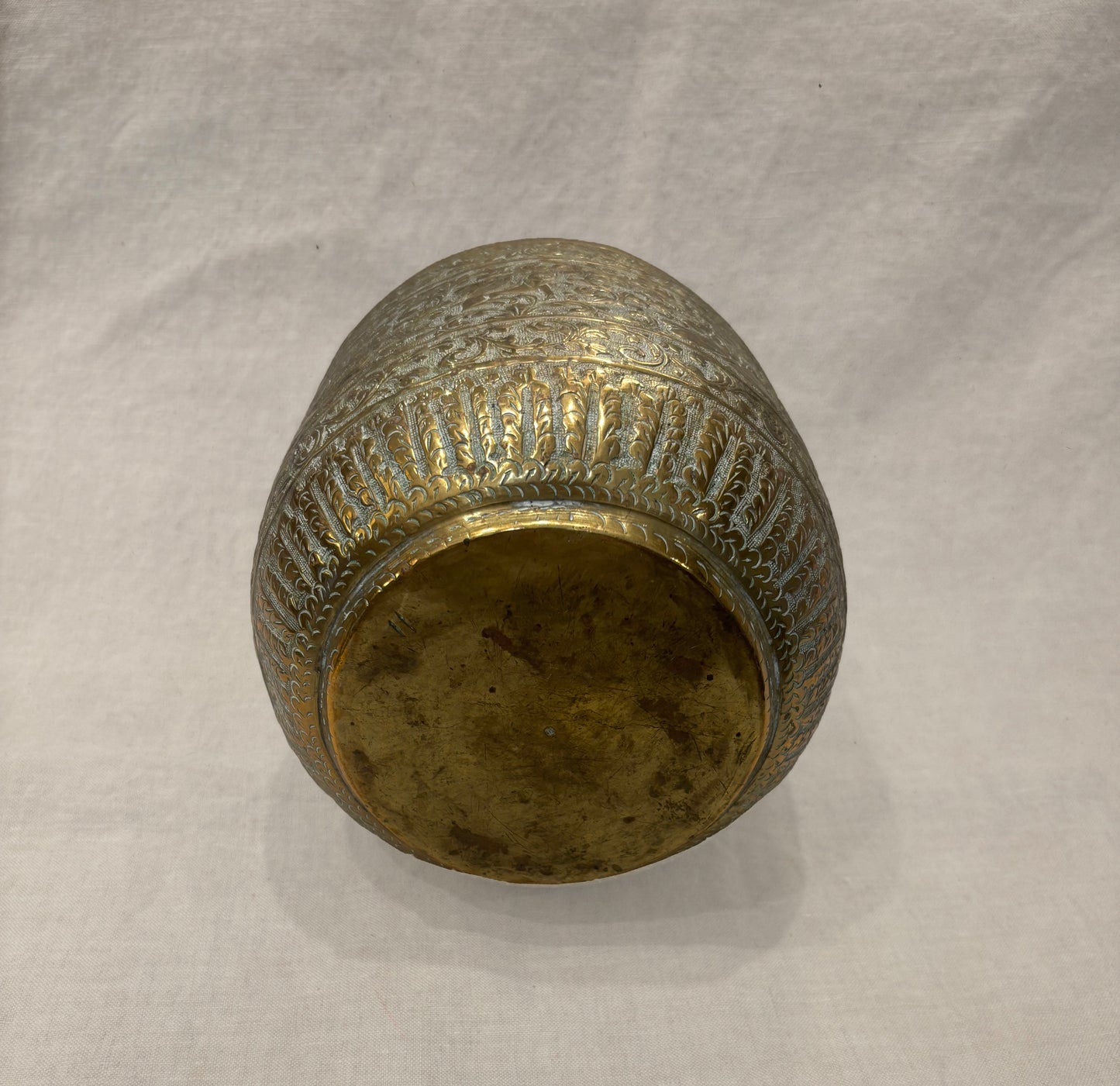 Hand-engraved Indian brass vessel with Mughal-inspired figures and floral motifs, bottom