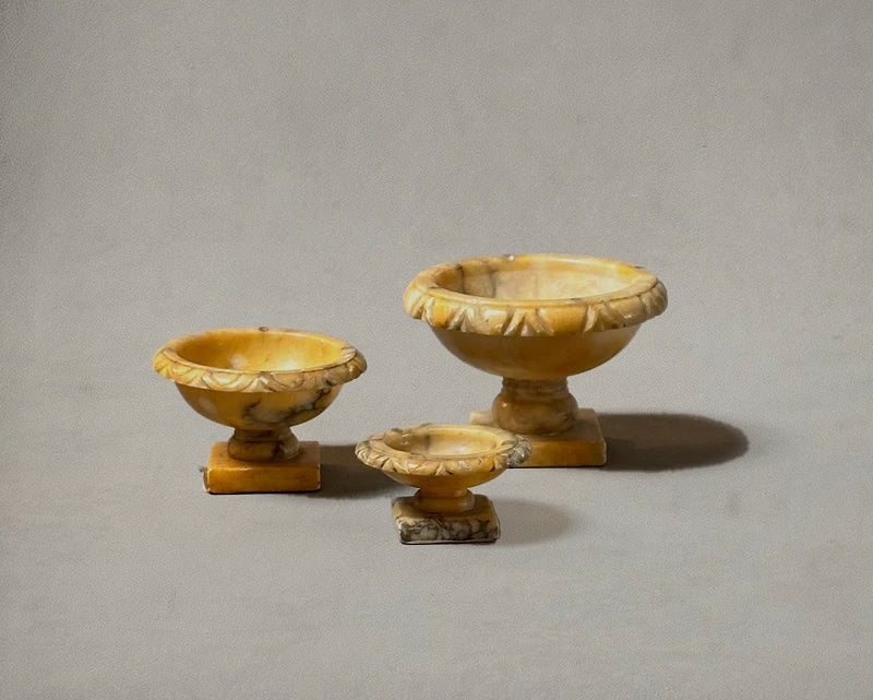 Set of three Italian alabaster tazzas with carved egg-and-dart rims and pedestal bases, circa 1750, profile