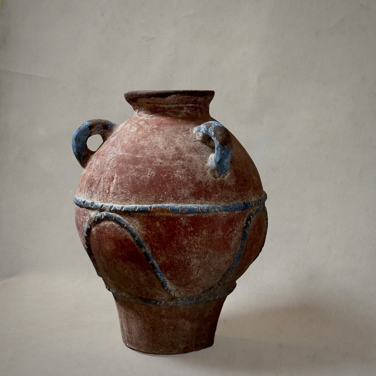 Mexican hand-painted terra-cotta vessel with blue detailing and three loop handles, 1980