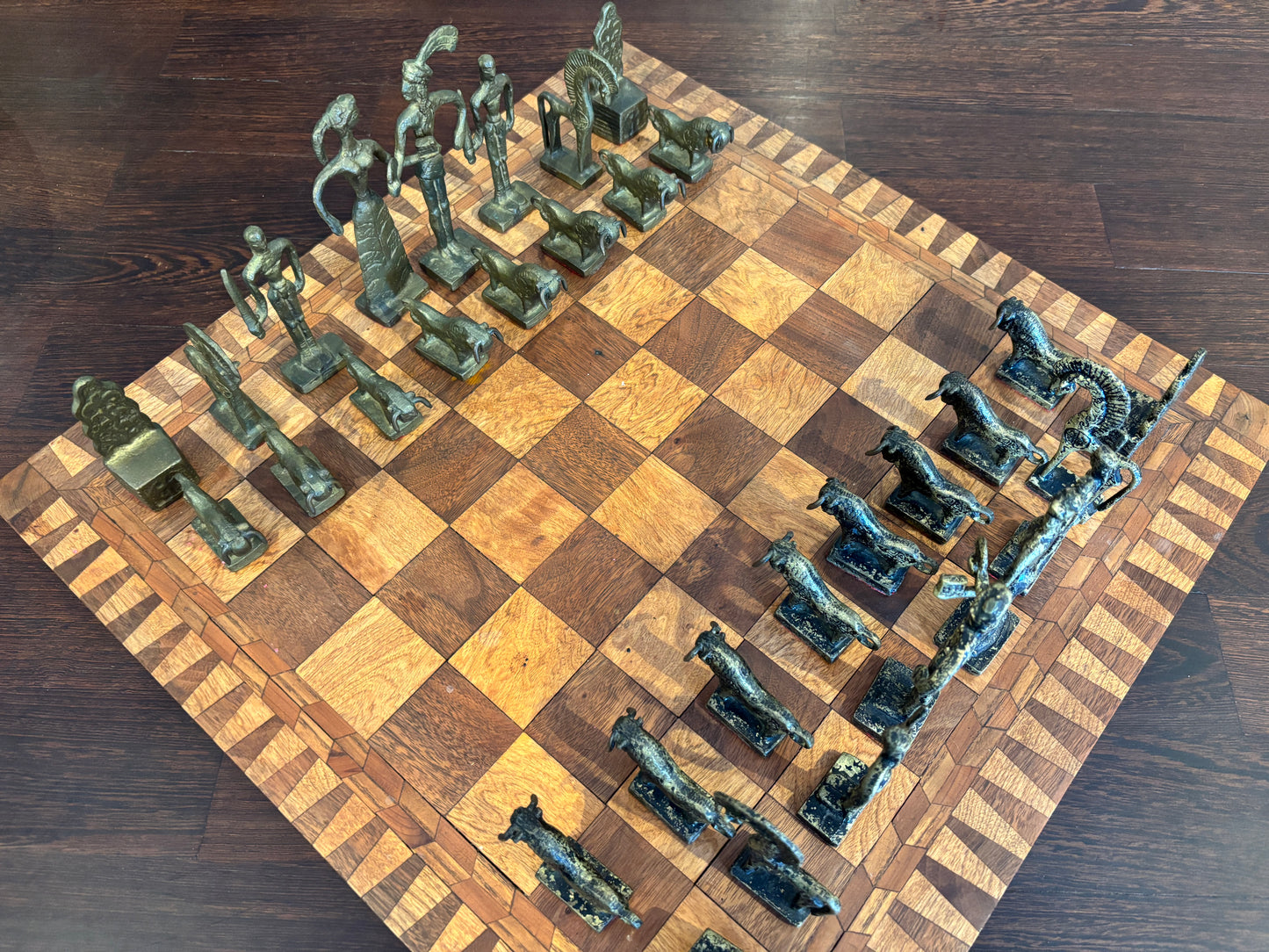 Bronze Minoan chess set by Christoforus Sklavenitis paired with antique English inlaid wood chessboard, diagonal side