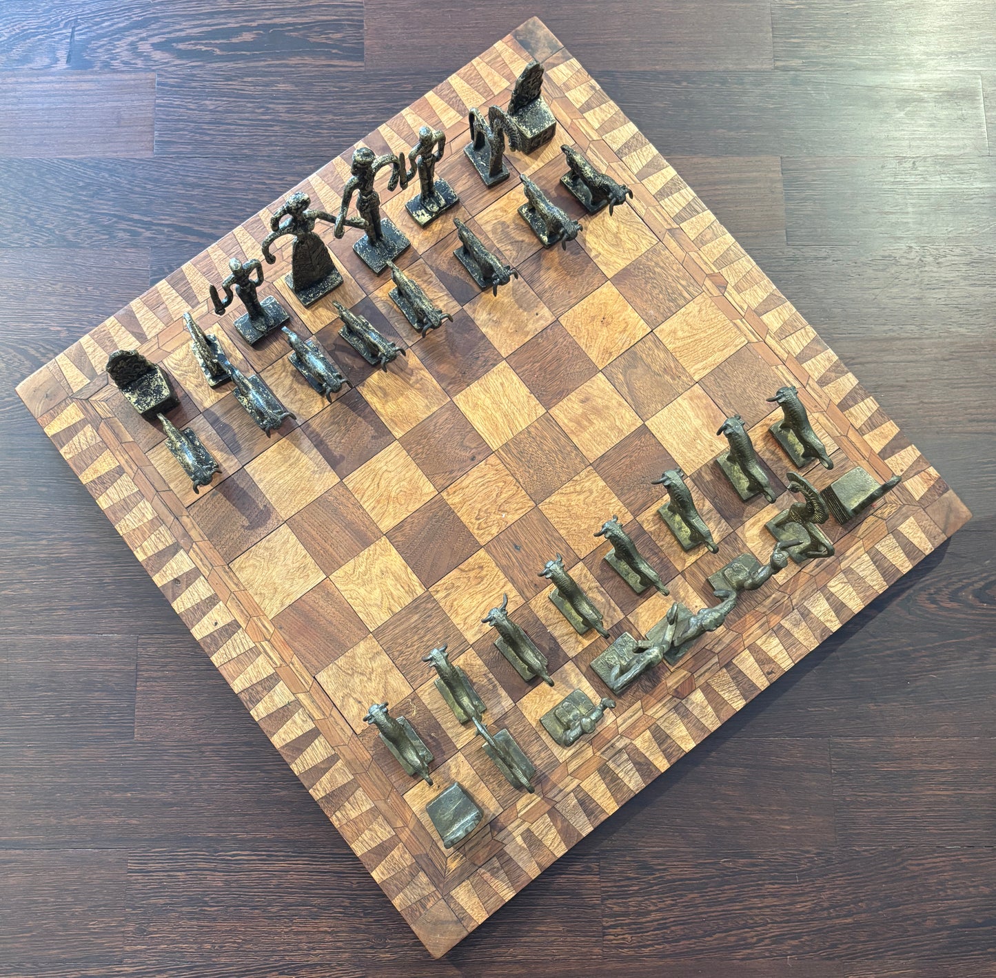 Bronze Minoan chess set by Christoforus Sklavenitis paired with antique English inlaid wood chessboard, diagonal