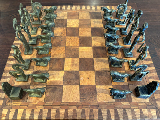 Bronze Minoan chess set by Christoforus Sklavenitis paired with antique English inlaid wood chessboard, frontal