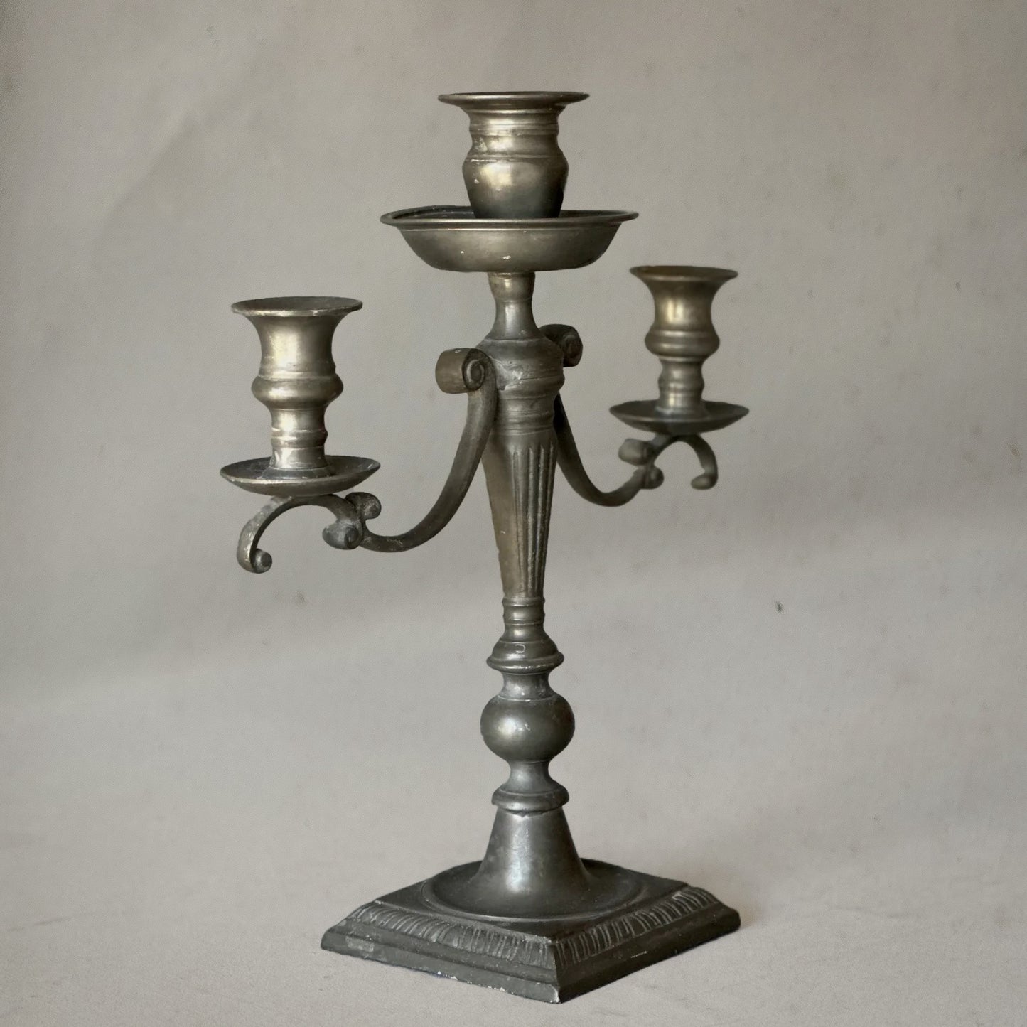 English pewter three-arm candelabra with fluted stem and scroll arms, circa 1840, right