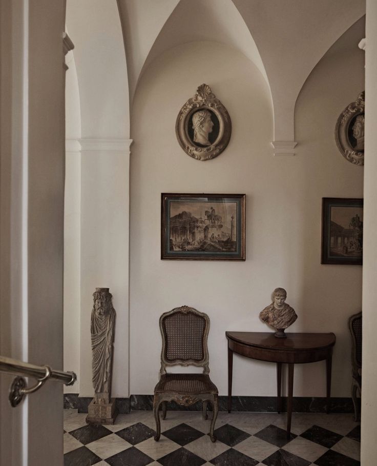 European dining room with classical columns, detailed molding, antique furniture, and natural light.