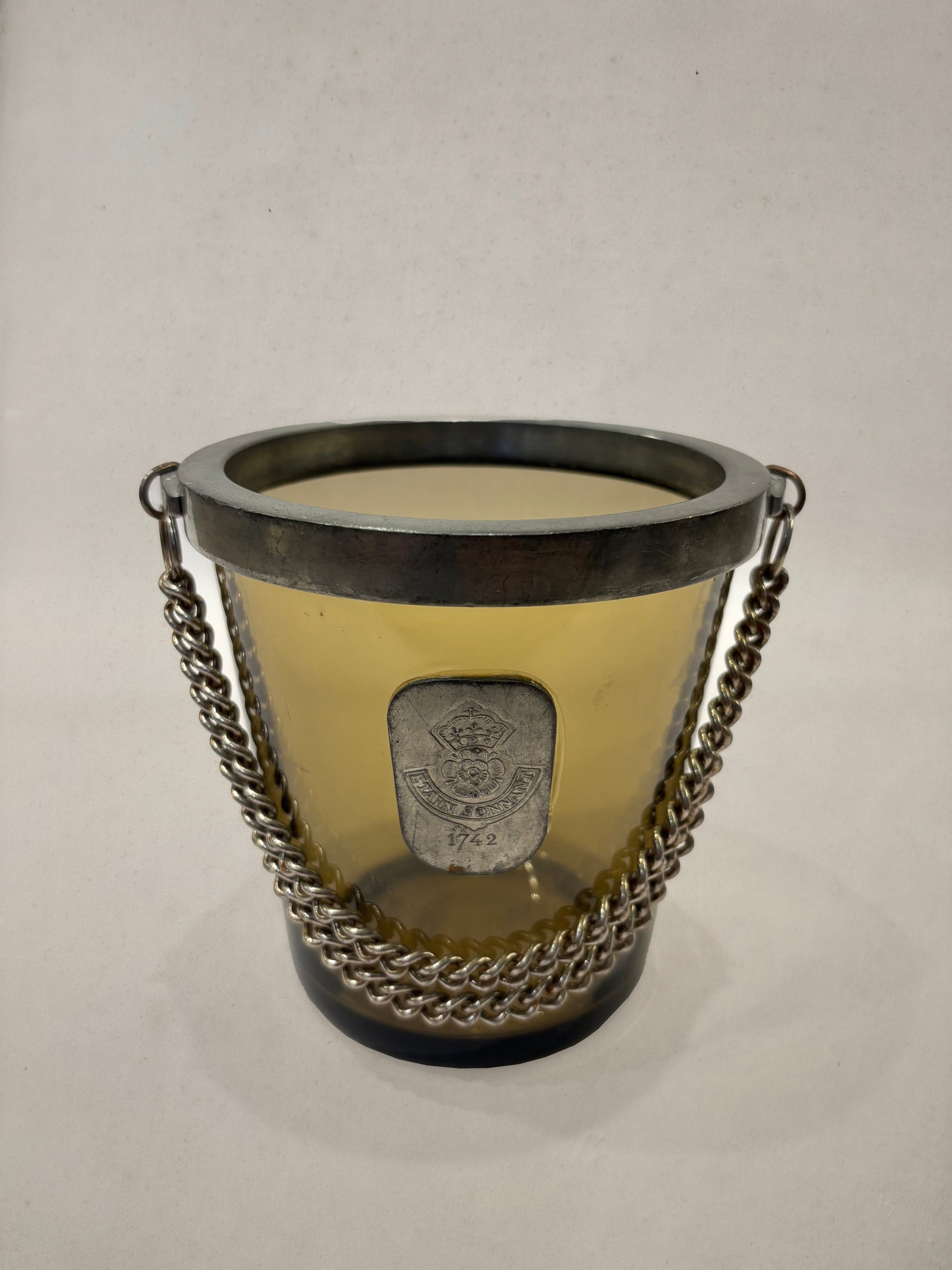Amber glass ice bucket with pewter medallion and chain, England, 1950s
