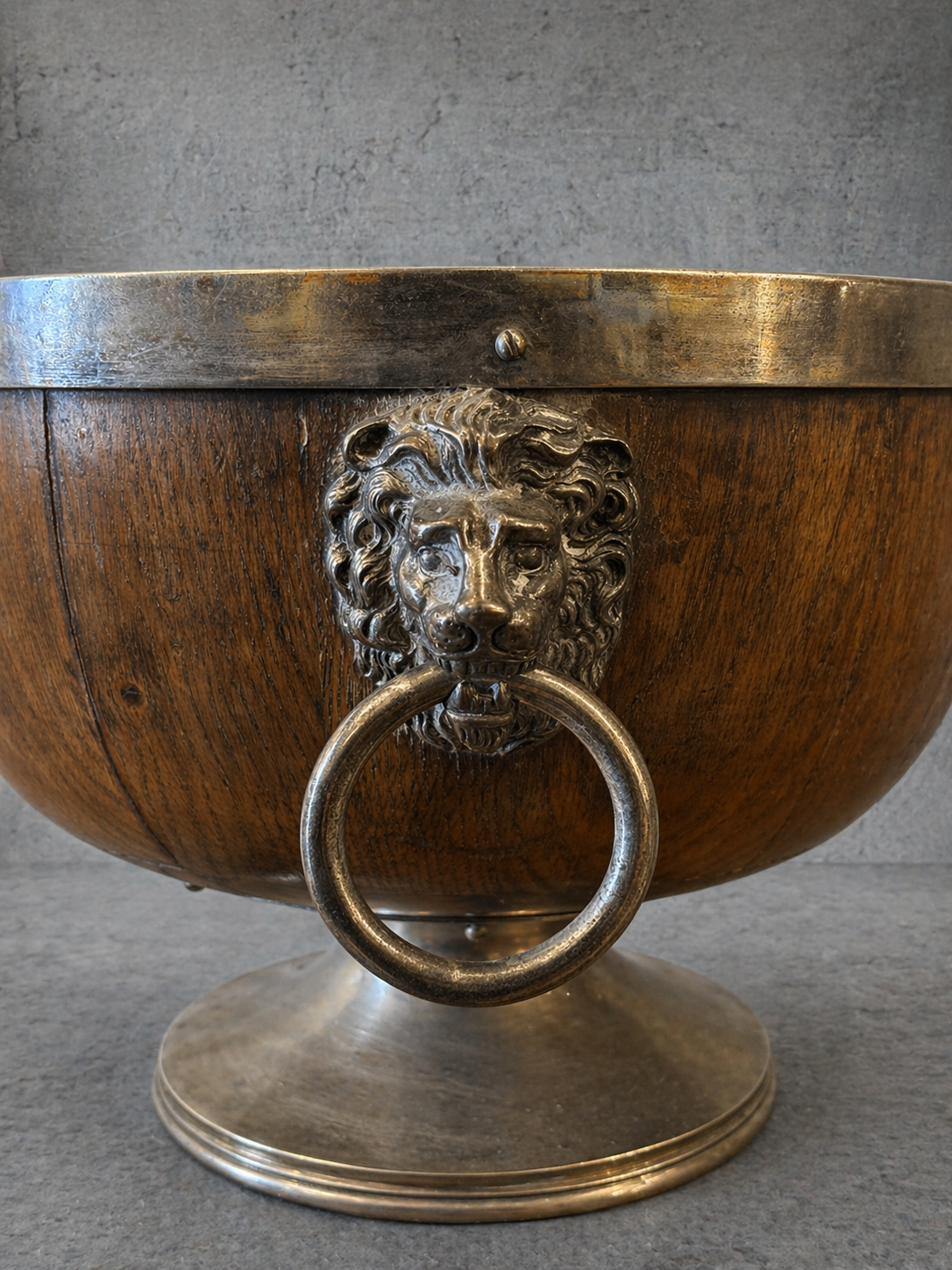 19th century English oak and silver plate wine cooler with lion mask ring handles, engraved September 1892 cartouche, coopered wood body, pedestal base, close up detail of lion handle