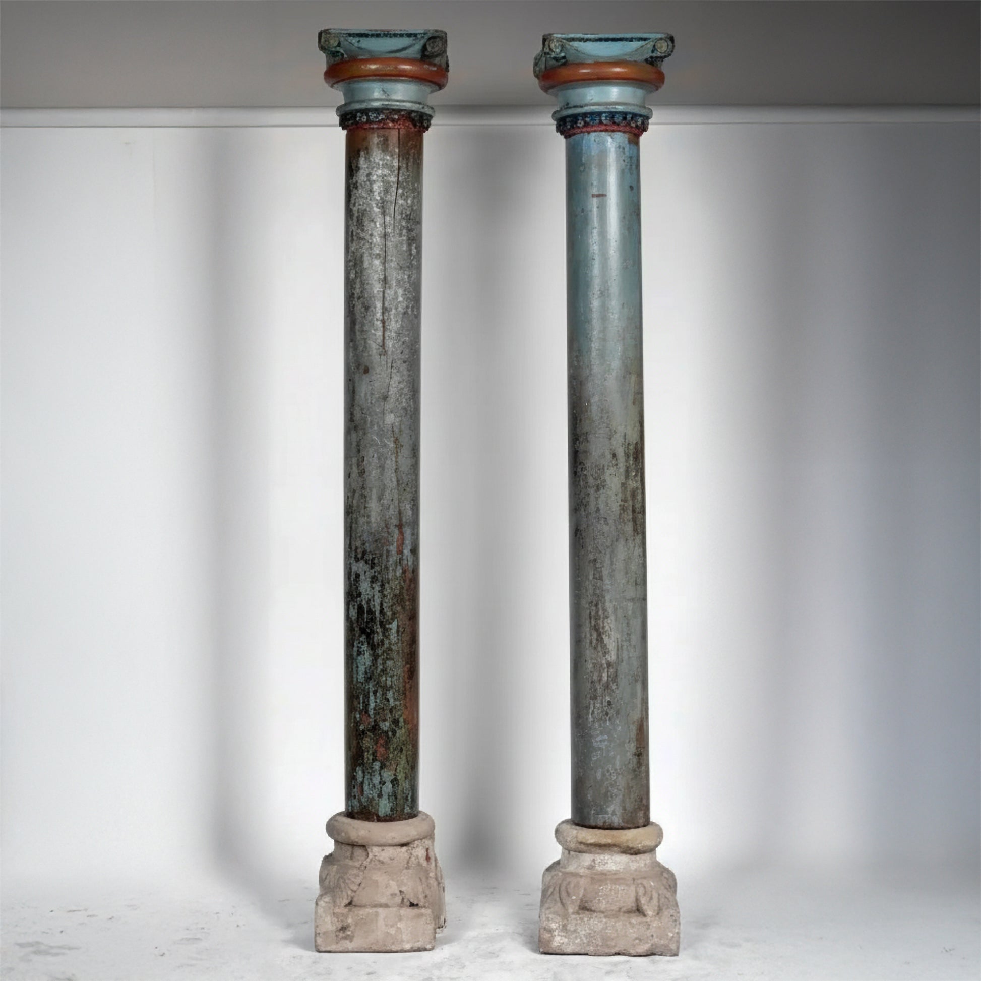 Pair of antique French painted architectural columns with aged aquamarine finish and stone bases