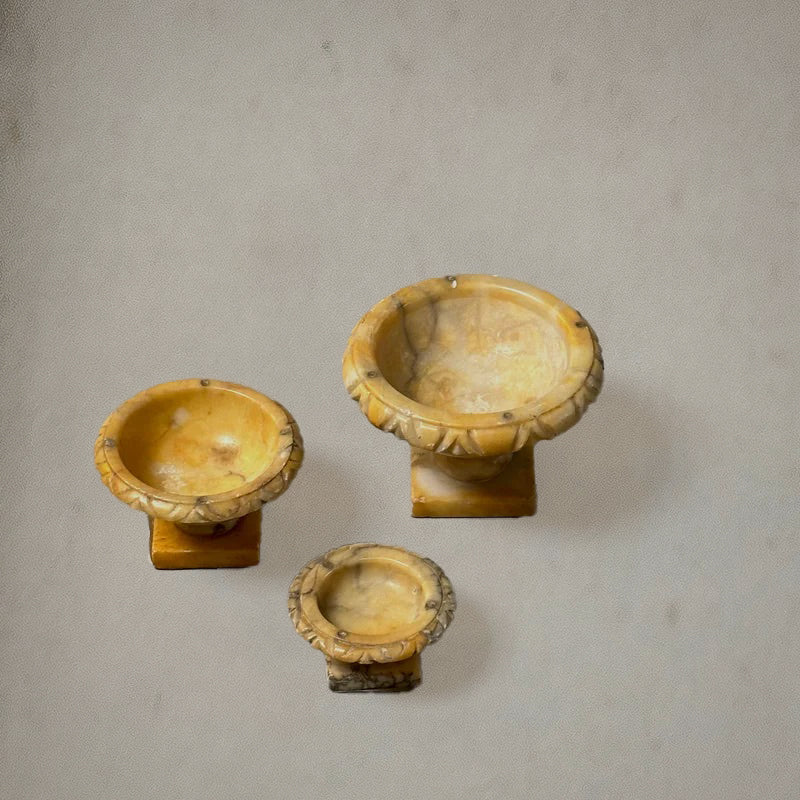Set of three Italian alabaster tazzas with carved egg-and-dart rims and pedestal bases, circa 1750, top