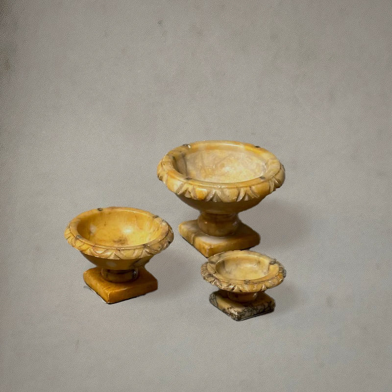 Set of three Italian alabaster tazzas with carved egg-and-dart rims and pedestal bases, circa 1750, profile top