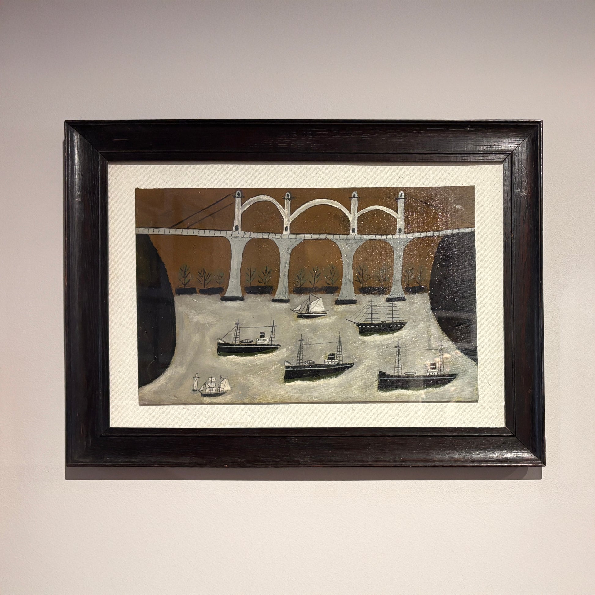 Framed folk-style painting by Max Wildman depicting boats beneath an arched bridge on a river