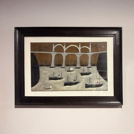 Framed folk-style painting by Max Wildman depicting boats beneath an arched bridge on a river
