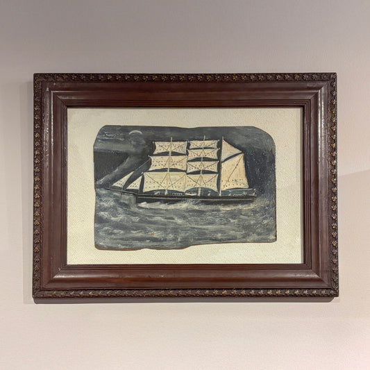 Maritime folk-style painting by Max Wildman showing a sailing ship at sea, framed in dark wood