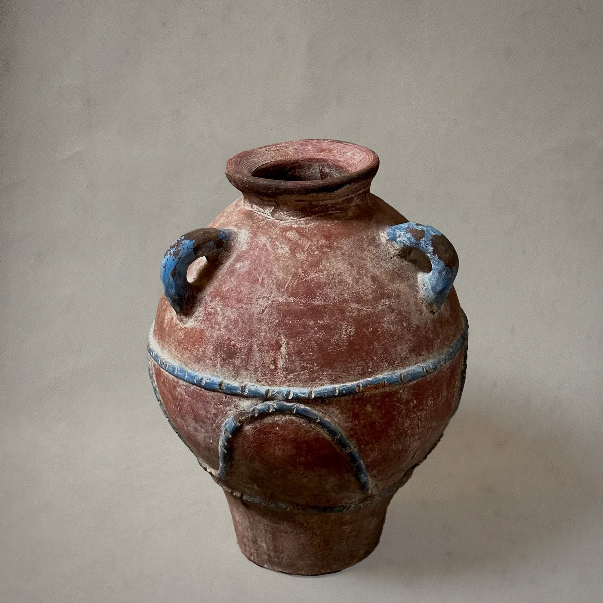 Mexican hand-painted terra-cotta vessel with blue detailing and three loop handles, 1980