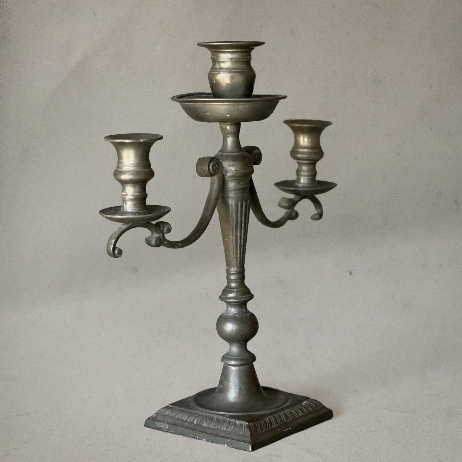 English pewter three-arm candelabra with fluted stem and scroll arms, circa 1840, right