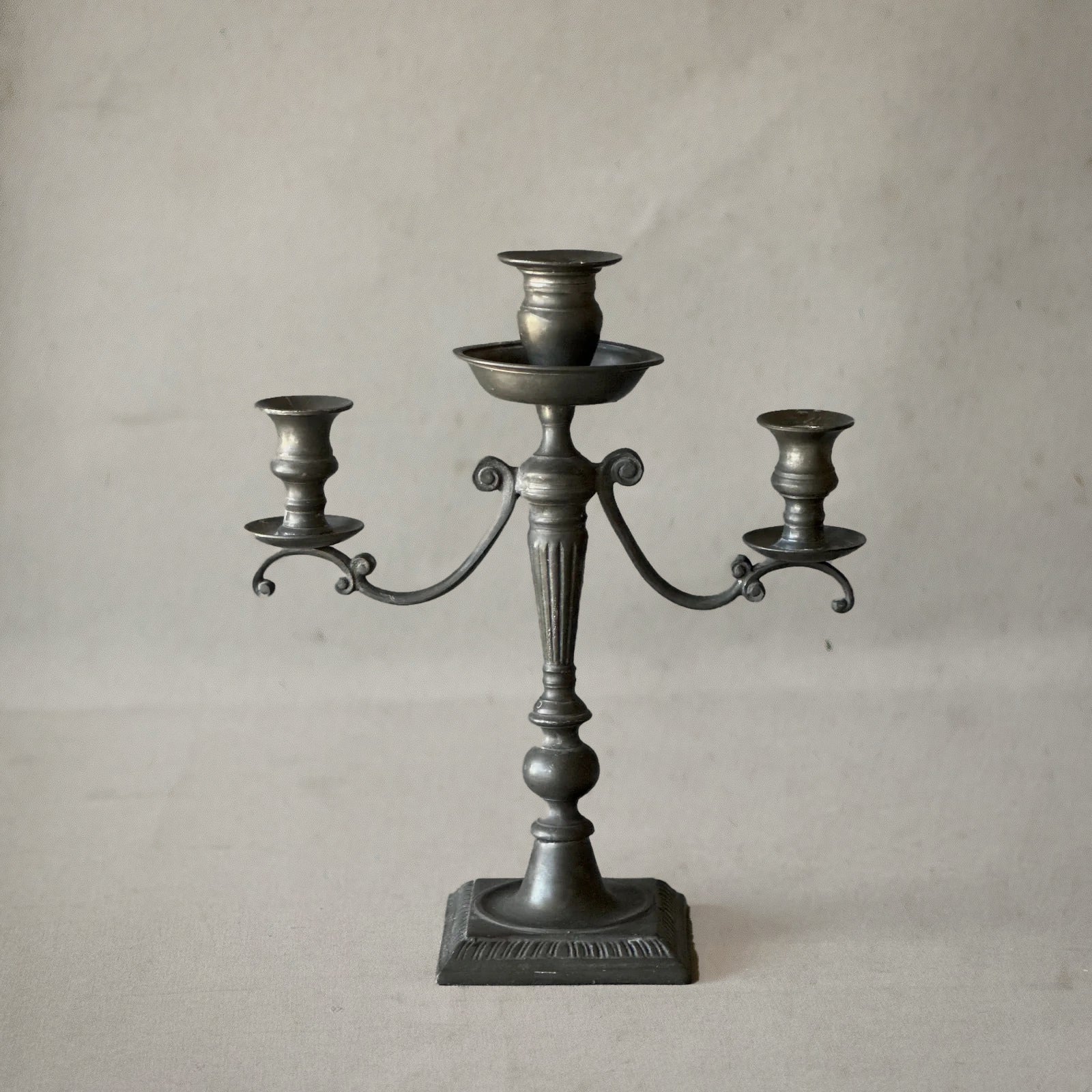 English pewter three-arm candelabra with fluted stem and scroll arms, circa 1840